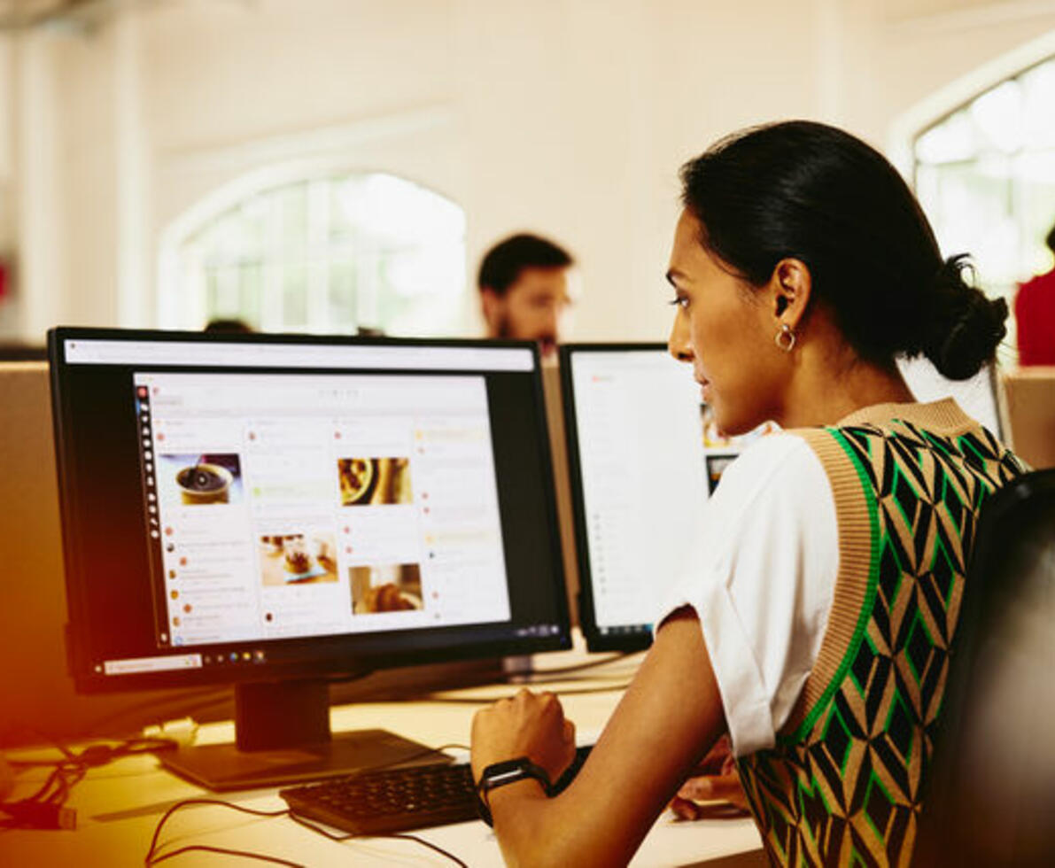 Woman sitting at a desk working on marketing platform. Woman sitting at a desk working on marketing platform.
